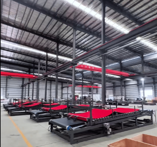 Conveyor system and processing unit for a high-speed laminating machine.a key link in achieving automated continuous production.