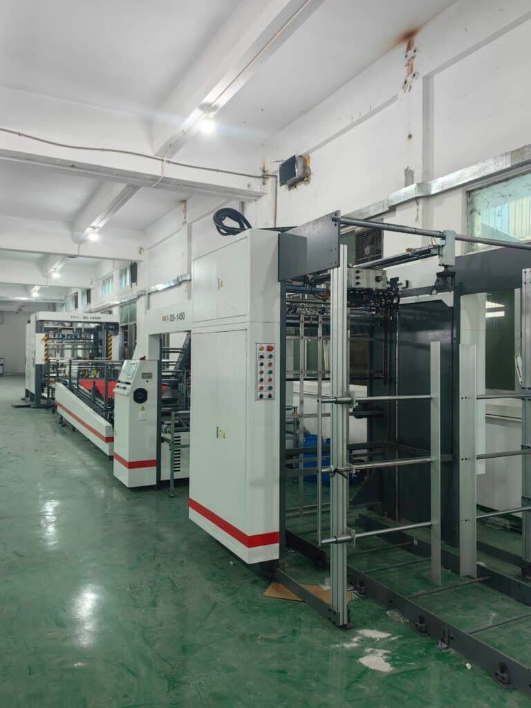 Automatic laminating machine production line, high-speed laminator operating in a carton packaging factory, with servo control system ensuring precise alignment and stable sheet delivery.