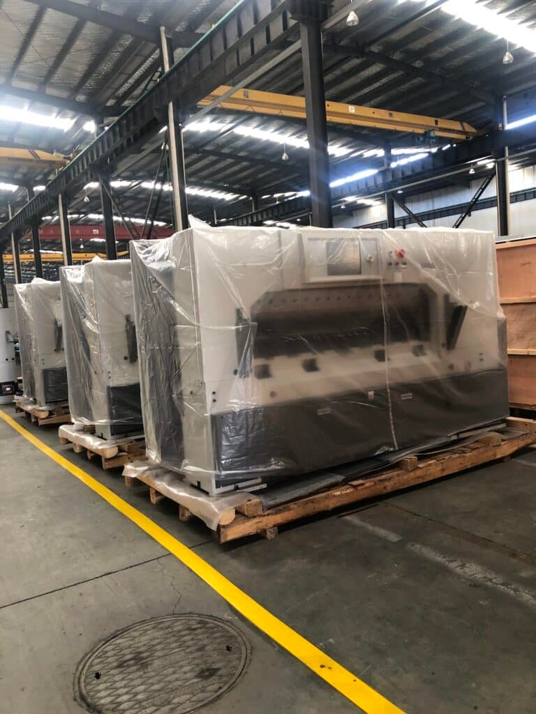 Industrial paper cutting machines packed and ready for shipment to global customers