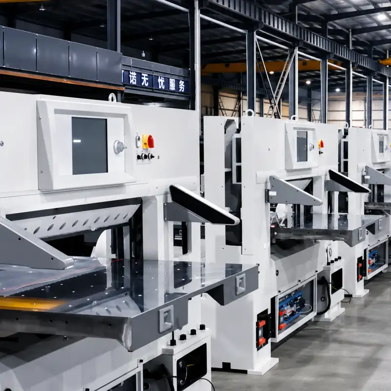 A row of modern automatic program-controlled paper cutting machines in a factory.