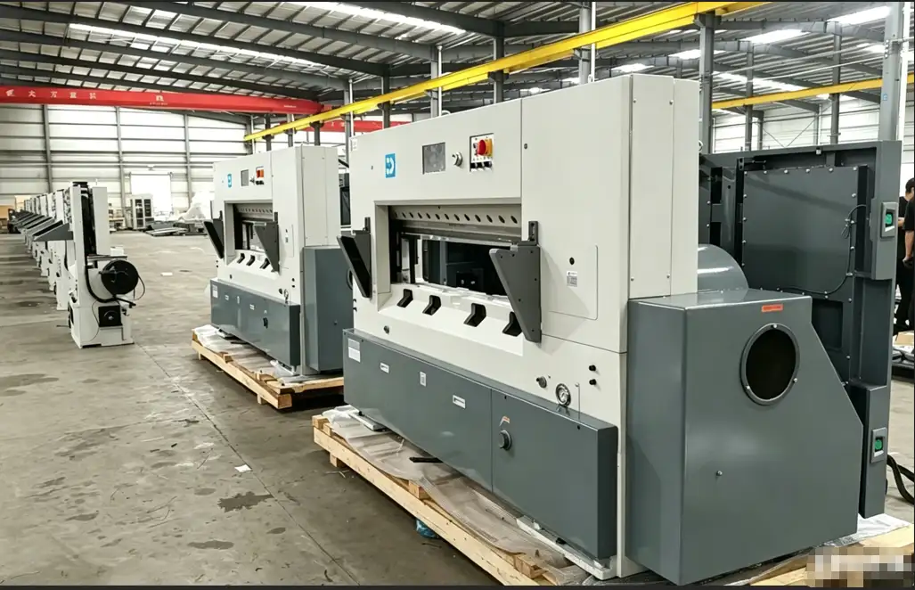 Finished automated paper cutting machines ready for shipment on wooden pallets, illustrating final-stage quality inspection and logistics preparation in smart factories.