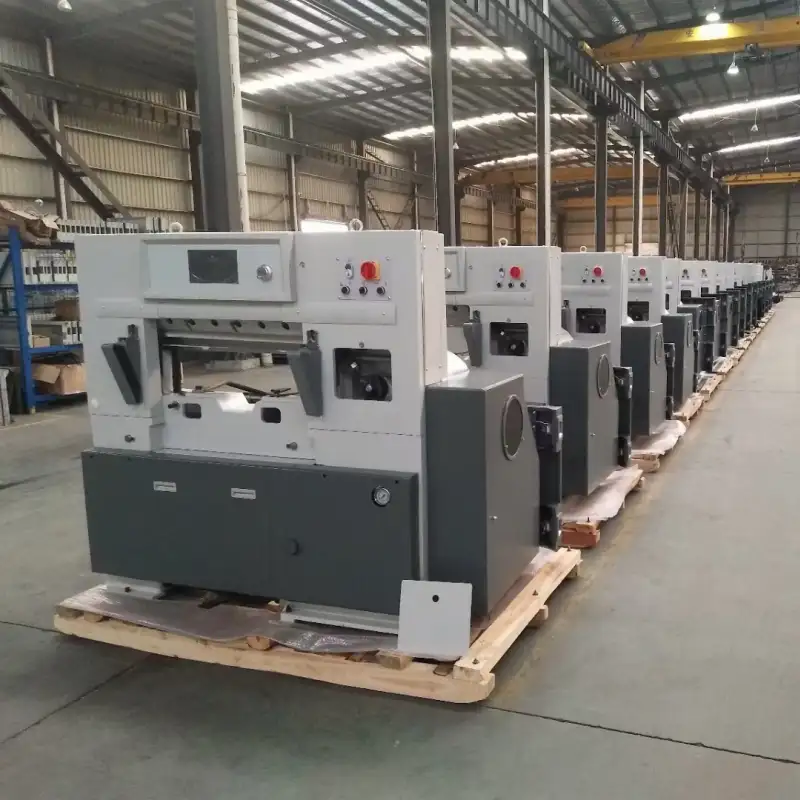 Mass production of industrial paper cutting machines in factory, showing equipment consistency and quality. equipment consistency.