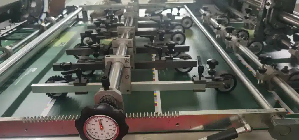 Precision pressure gauge and adjustment knobs inside a die cutting machine for fine-tuning cutting force.