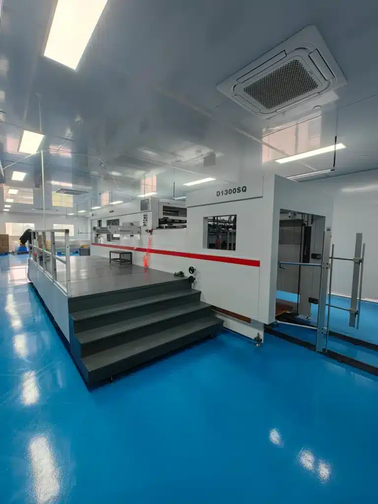 Full view of DAI'S D1300SQ fully automatic die cutting machine in cleanroom environment.