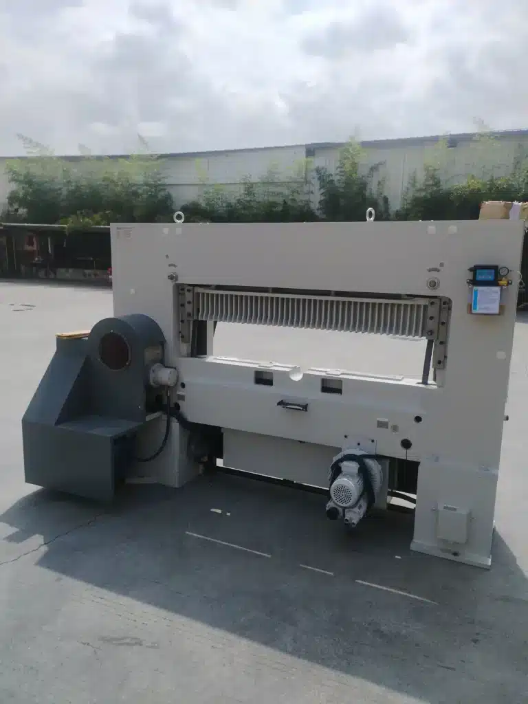 Side view of high-speed paper cutter highlighting hydraulic system and drive components affecting vibration and wear