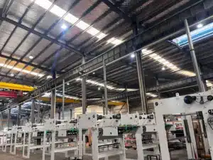 Wide-angle view of a modern die cutting workshop with multiple machine frames and overhead cranes.