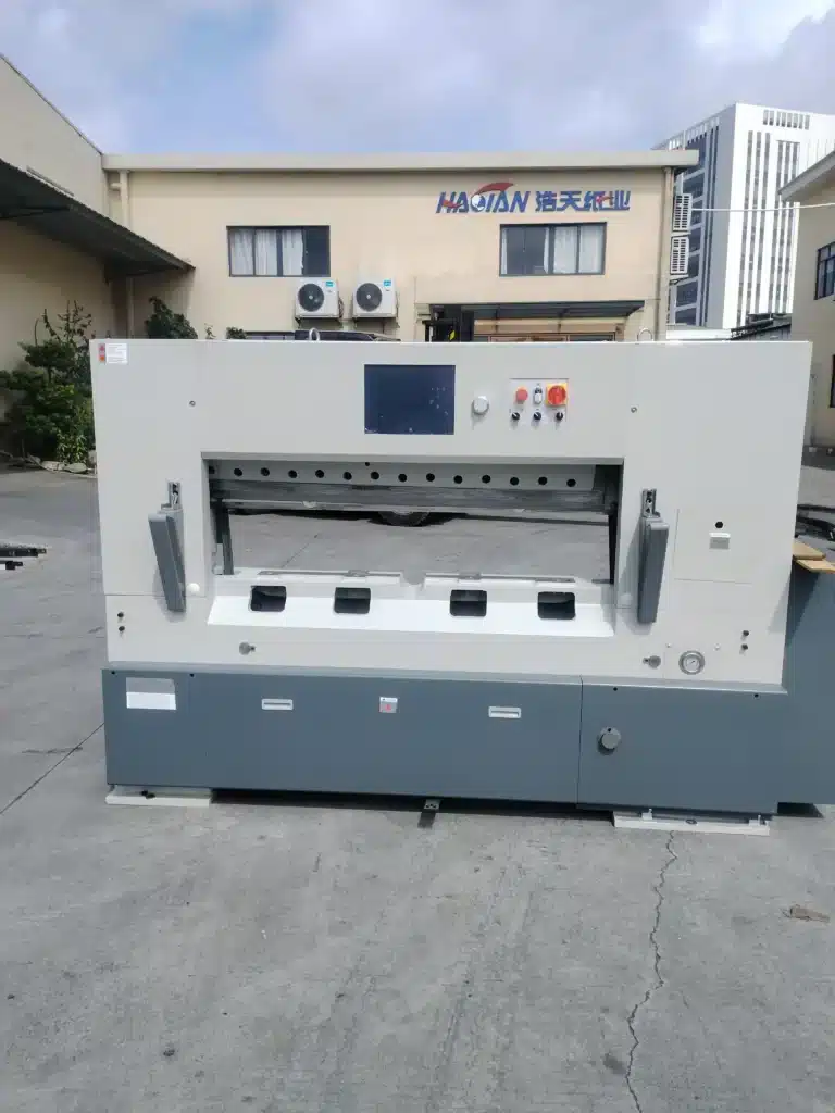 Outdoor display of modern high-speed paper cutter showcasing advanced technology and industrial design for packaging applications