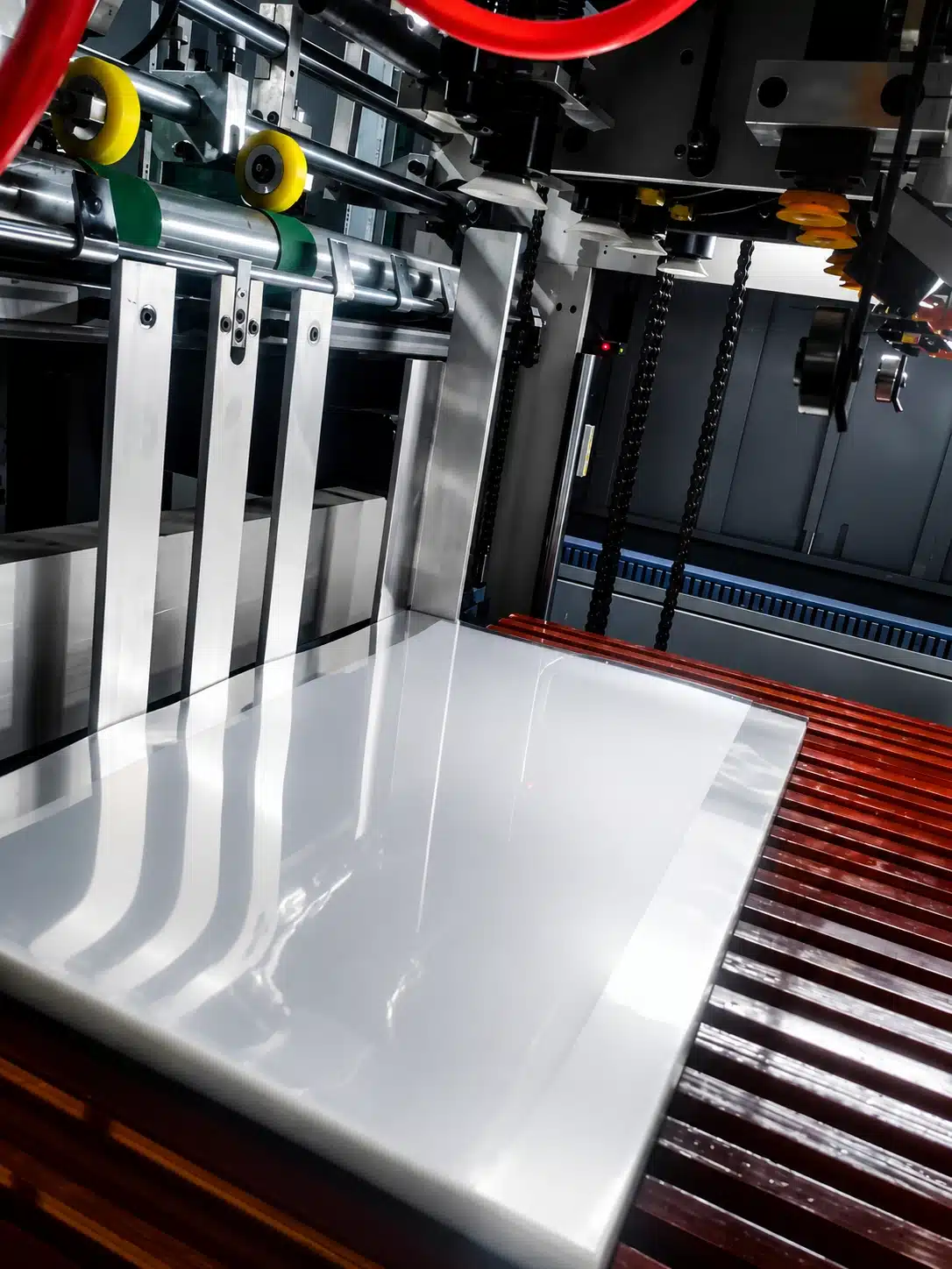High-speed die cutting machine processing glossy paperboard sheet for precision packaging