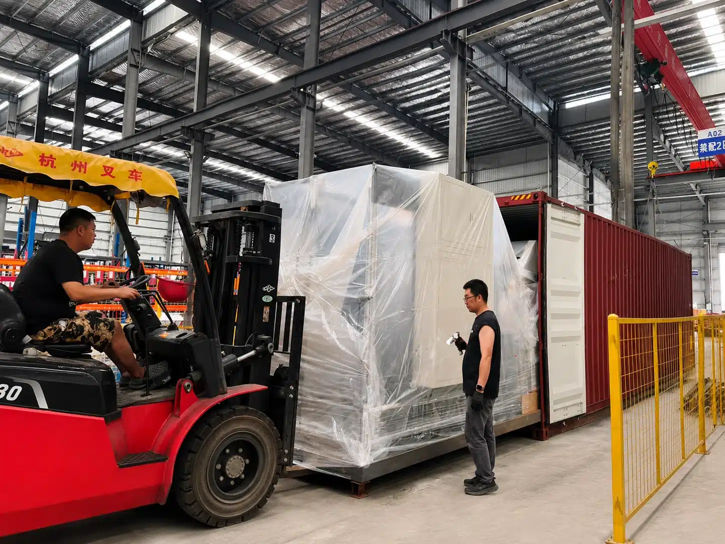 Die cutting machine being loaded into an export container at DAIS factory