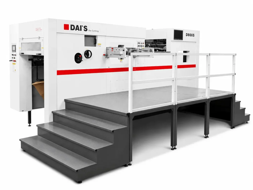 Side-by-side comparison of manual platen press and semi-automatic flatbed die cutter in a packaging plant illustrating when to upgrade for higher output and lower labor cost