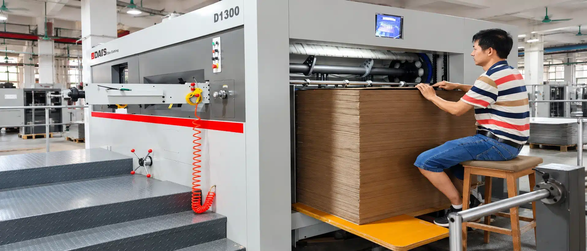 DAIS D1300 Semi-Automatic Die Cutting Machine manual paper feeding area showing cardboard alignment and sheet entry into the machine.